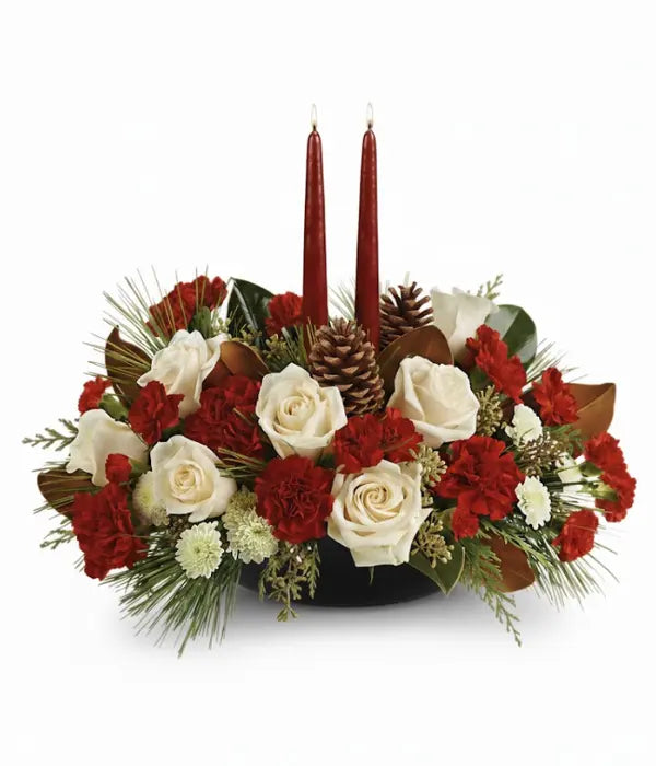 Christmas pine centerpiece with red and white flowers and candles