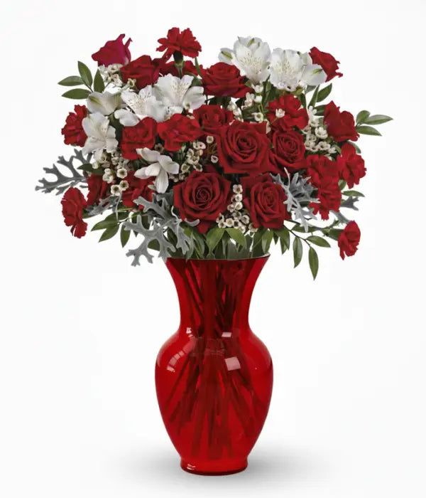 Crimson Snow Elegance Deluxe floral arrangement in red vase