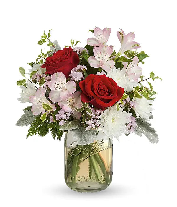 Red roses & mixed flowers in a mason jar.