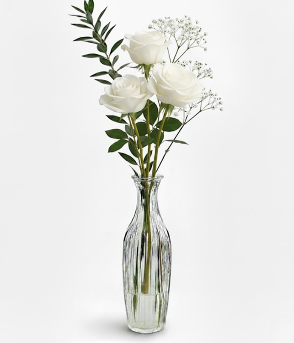 White roses in bud vase from florist